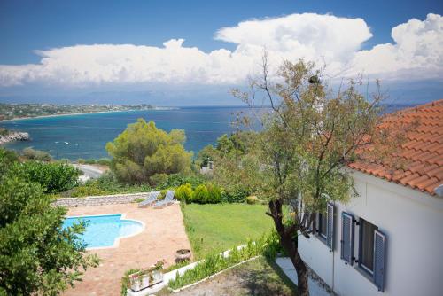a house with a swimming pool and a view of the water at Akritas in Koroni