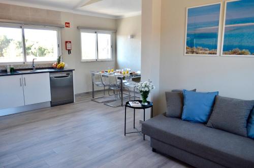 a living room with a couch and a kitchen at Villa ELTAEL - Rita Apartment - Warm Pool from April 2026 in Manta Rota