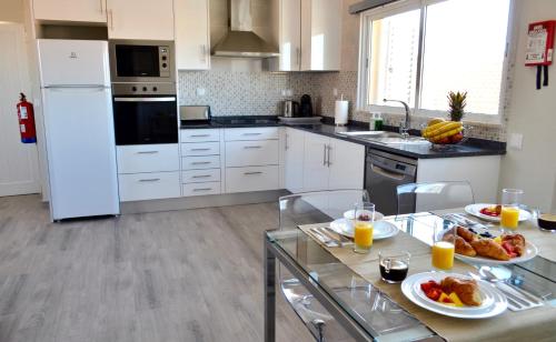 a kitchen with two plates of food on a table at Villa ELTAEL - Rita Apartment - Warm Pool from April 2026 in Manta Rota