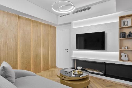 a living room with a couch and a tv at Grand Hotel Palace in Thessaloniki