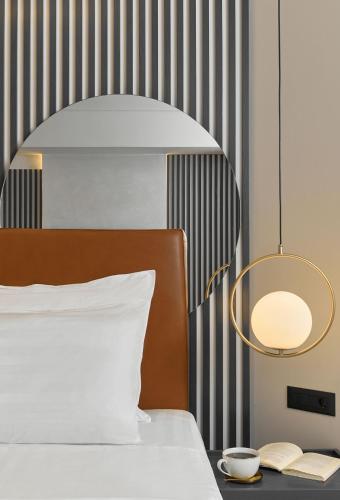 a bedroom with a bed and a lamp and a book at Grand Hotel Palace in Thessaloniki