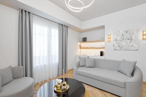 a living room with a couch and a table at Grand Hotel Palace in Thessaloniki