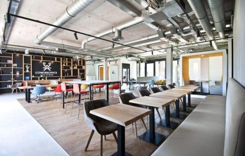 a group of tables and chairs in a room at Coloft in Lesquin