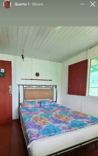 a large bed in a room with at Pousada Amazônia Encantada in Iranduba