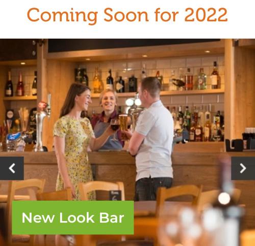 a man and a woman standing at a bar at private rented caravan situated at Southview holiday park in Winthorpe