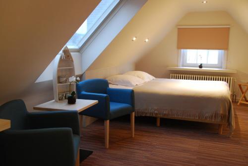 Een bed of bedden in een kamer bij Hotel Rubens