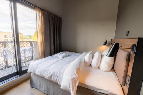 a bedroom with a bed and a large window at Lily Country Club in Klofta