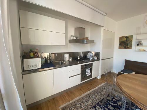 a small kitchen with a sink and a microwave at CASA SANDRA in Crema