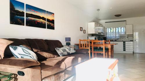 a living room with a brown couch and a table at Welooveyou Bahia Sunlight in Costa Calma