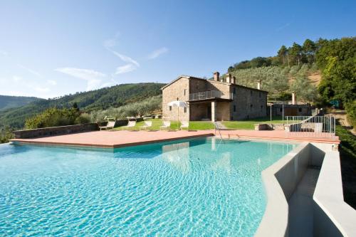 a large swimming pool in front of a building at Poggio di San Biagio in Cantagrillo