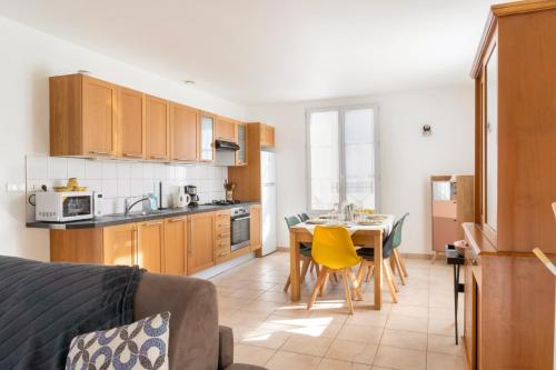 une cuisine avec une table et une salle à manger dans l'établissement Maison de bourg à deux pas de la mer, à Saint-Brévin-les-Pins