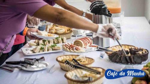 a group of people preparing food on a table at Asenza Beach Resort All Inclusive in Pitimbu