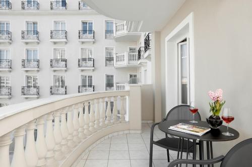 a balcony with a table and chairs and a building at Grand Hotel Palace in Thessaloniki