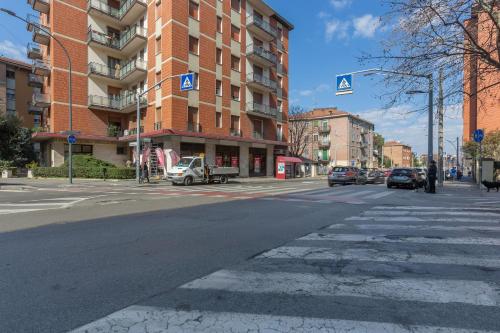 an empty city street with cars parked in front of a building at a 500 mt dalla Certosa Apartment in Bologna
