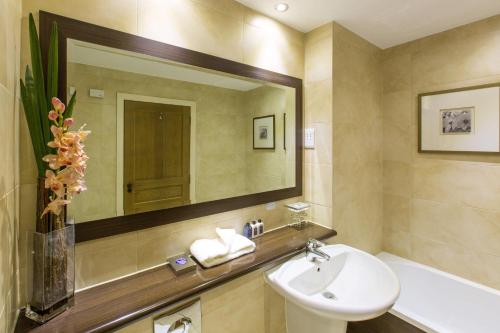 a bathroom with a sink and a mirror at Cameron Club Lodges in Balloch