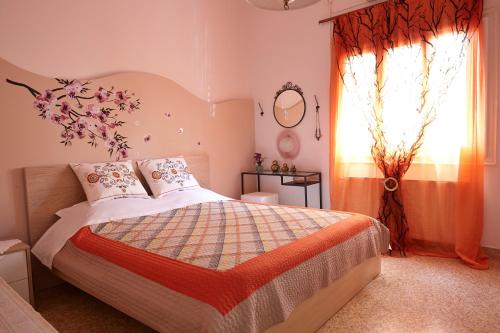 a bedroom with a bed and a window at House with Yard by the Hill in Athens