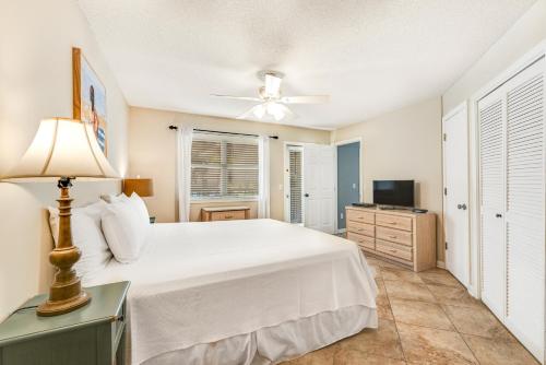 a bedroom with a white bed and a ceiling fan at Summer Breeze 21 in Orange Beach