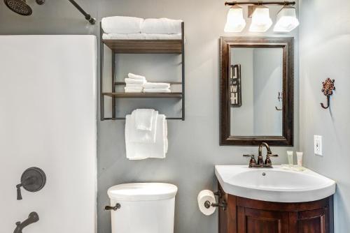 a bathroom with a sink and a toilet and a mirror at Summer Breeze 21 in Orange Beach