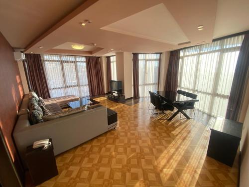 a living room with a couch and a piano at Grand Hills in Yerevan