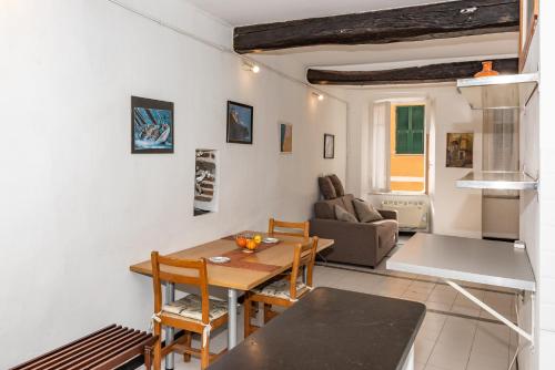 a kitchen and living room with a table and chairs at Casa Lucio by Arbaspàa in Vernazza