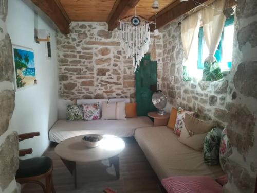 a living room with a couch and a table at Gallery House Plouti in Ploutí
