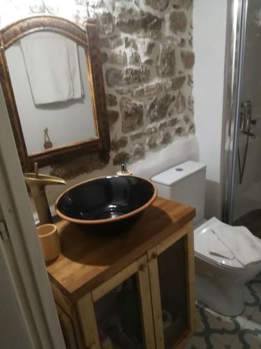 a bathroom with a sink and a toilet at Gallery House Plouti in Ploutí