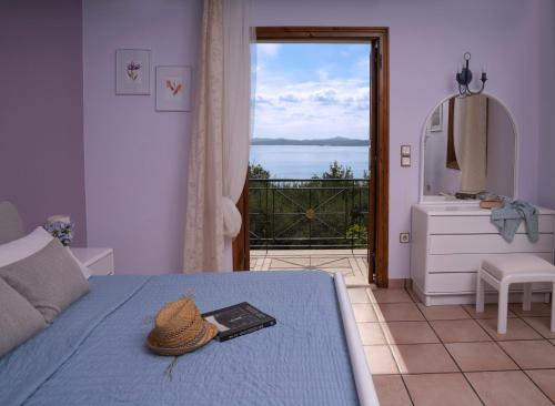 a bedroom with a bed with a hat on it at Jasmin Villa Nissaki in Nisakion