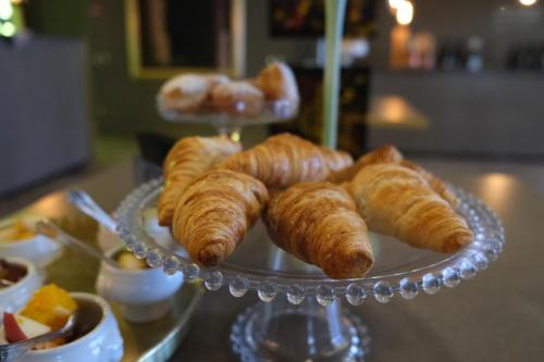 a plate of croissants and other pastries on a table at Settecento Hotel in Presezzo