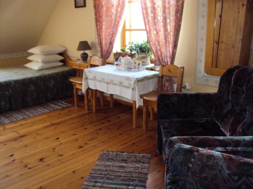 a living room with a table and a couch at Saule in Talsi