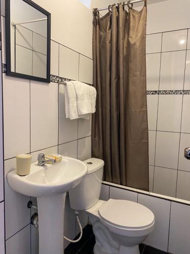 a bathroom with a toilet and a sink at Hotel Munay in Paracas
