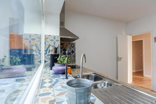 una cucina con un lavello e un piano di lavoro di Casa das Rosas by MP a Vila Nova de Gaia