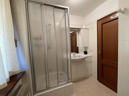 a bathroom with a shower and a sink at 072 Trilocale, Giustino in Giustino