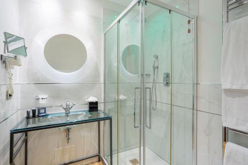 a bathroom with a glass shower and a sink at Bianca Maria Palace Hotel in Milan