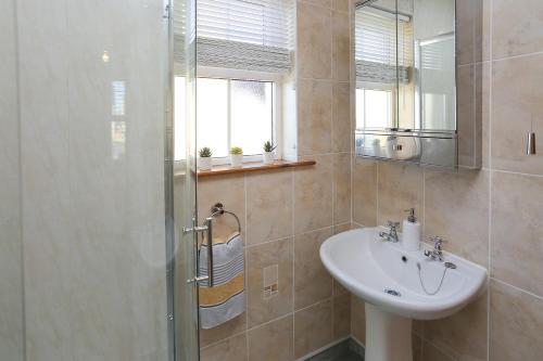 a bathroom with a sink and a shower at The Ferns-Ideal base for exploring the Causeway Coast in Armoy