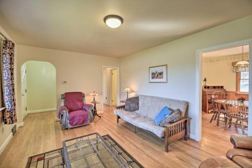 a living room with a couch and a chair at Quaint Creekside Home with Spacious Deck and Yard in Atkins