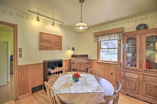 a dining room with a table and a kitchen at Quaint Creekside Home with Spacious Deck and Yard in Atkins