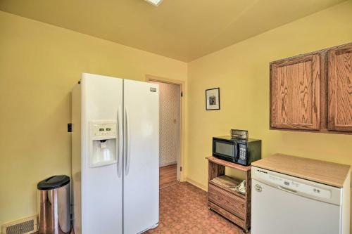 a kitchen with a white refrigerator and a microwave at Quaint Creekside Home with Spacious Deck and Yard in Atkins