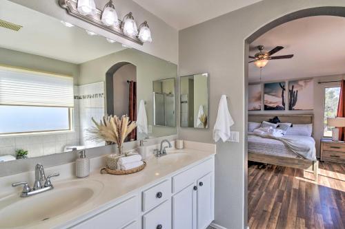a bathroom with two sinks and a bedroom with a bed at Avondale Oasis with Pool 5 Mi to State Farm Stadium in Avondale