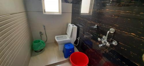 a small bathroom with a toilet and a sink at The PALM SUITES , Incredible India Tourism in Guwahati