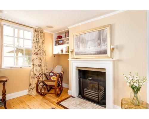 a living room with a fireplace with a tv above it at Murphys House - 3 bed Luxury Central Townhouse in Bath
