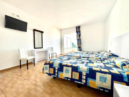 a bedroom with a bed and a television in it at Hotel Casa del Sol in Puerto de la Cruz