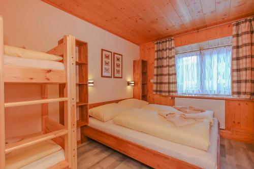 a bedroom with two bunk beds and a window at Appartements Schmidsendl in Lofer