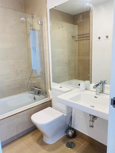 a bathroom with a toilet and a sink and a shower at Sunrise in Manilva in Manilva