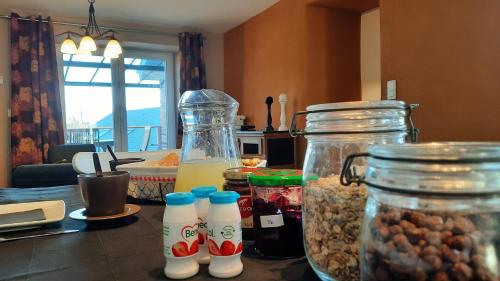a kitchen counter with two glass containers filled with food at D'un coin à l'autre in Nadrin