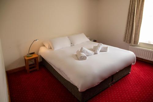 The Knighton Apartmentにあるベッド