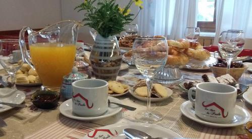 a table full of food and glasses of orange juice at Hosteria Casa de Paula in Trelew