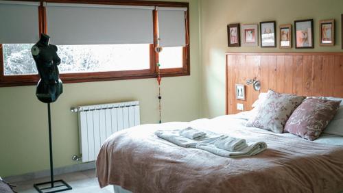 a bedroom with a bed with a robe on it at Hosteria Casa de Paula in Trelew
