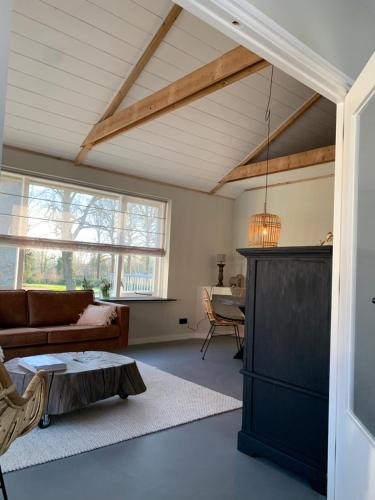 a living room with a couch and a table at Appartement Het Bovenhuys in Baflo