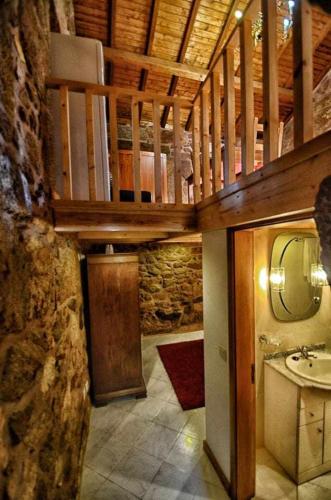 a bathroom with a sink and a mirror at Casa das Vinhas (Camélias de Basto-Turismo Rural) in Celorico de Basto