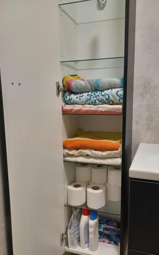 a closet with a glass door with towels at Atkacs Home in Győr